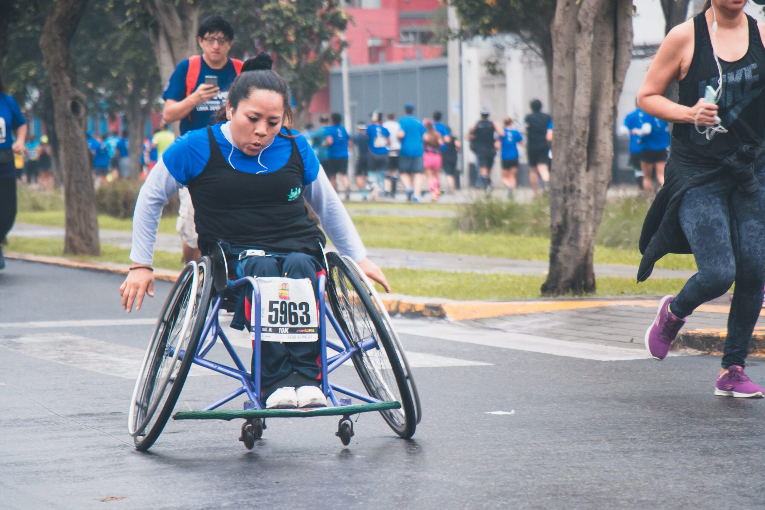 A woman in a wheelchair participating in a run, roll and walk-a-thon