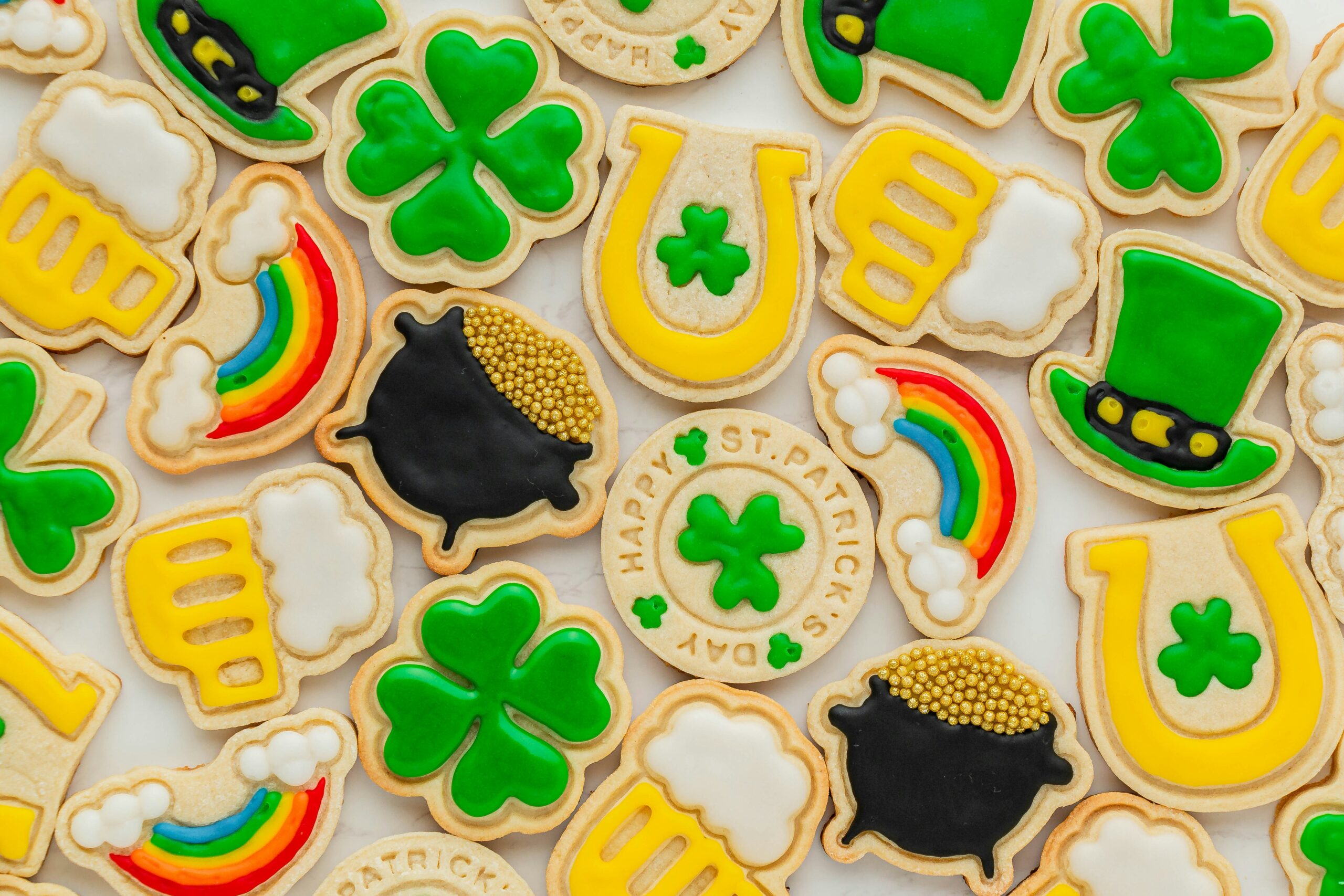 St. Patrick's day fundriasing ideas - green baking cut out sugar cookies decorated as pots of gold and shamrocks for St. Patrick's Day