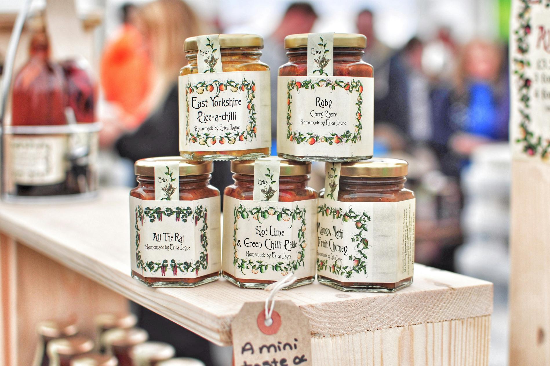ars of homemade chutney, curry paste, and pickle for sale at a community market stall — homemade goods are a popular product fundraiser.